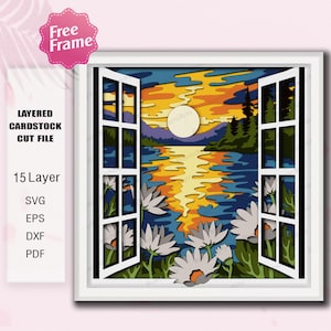 May include: A layered cardstock cut file depicting a sunset scene viewed through an open window. The artwork features a lake, mountains, trees, and flowers, with a bright sun. The image includes the text "Free Frame" and "Layered Cardstock Cut File".