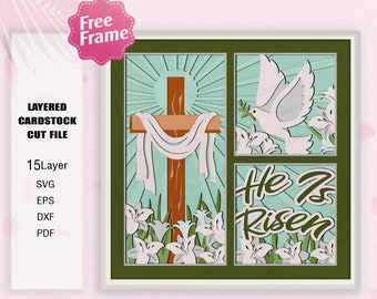 May include: A layered cardstock cut file design featuring a cross with a white cloth draped over it, a dove with an olive branch, and the text "He Is Risen" surrounded by white lilies. The design is set against a green background with a white frame.