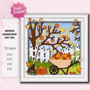 May include: A layered cardstock cut file design depicting an autumnal scene. The artwork includes a tree with falling leaves, a white picket fence, a wheelbarrow filled with leaves, a pumpkin, and a rake. The design has 13 layers and is available in SVG, EPS, DXF, and PDF formats.