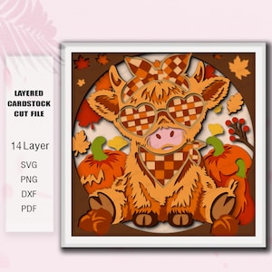 May include: A layered cardstock cut file featuring a Highland cow wearing a checkered bow and heart-shaped glasses, surrounded by pumpkins and autumn leaves. The text reads: LAYERED CARDSTOCK CUT FILE, 14 Layer, SVG, PNG, DXF, PDF. The design is orange and brown.
