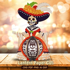May include: A layered paper cut lantern featuring a skeletal figure wearing a wide-brimmed hat adorned with yellow flowers and white feathers. The figure wears a red dress with ruffled sleeves and a central lantern element with skull motifs.