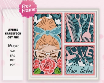 May include: A layered papercraft design featuring a woman with a blue headband and glasses, surrounded by roses. The design is divided into three sections, with the woman in the center and the words "Hair Salon" and a pair of scissors in the other sections. The design is in pink, blue, green, and white.