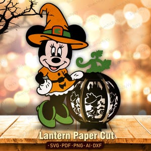 May include: A layered paper cut design featuring a cartoon mouse character wearing an orange witch hat and dress, standing next to a black spherical lantern with cut-out silhouettes of a witch and bats. Text reads: Lantern Paper Cut.