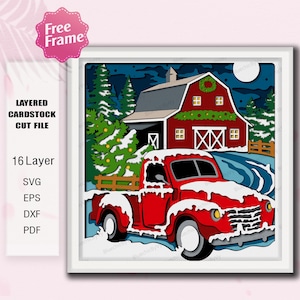 May include: A layered cardstock cut file featuring a red vintage truck driving past a red barn in a winter scene. The image includes a Christmas tree, snow, and the text "Free Frame".