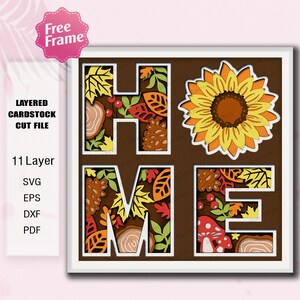 May include: A layered cardstock cut file design spelling "HOME" with autumn-themed elements. The design includes a sunflower, leaves, and other fall-themed details. The image also includes the text "Free Frame" and "11 Layer".