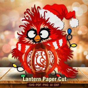 May include: A red cardinal bird illustration wearing a white-trimmed red Santa hat and a red and white striped scarf. The bird holds a round red lantern featuring a cardinal silhouette. Decorative string lights with blue, yellow, and green bulbs.