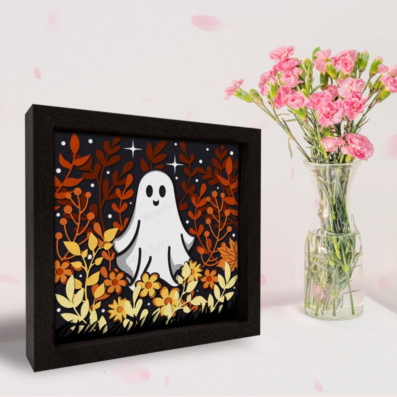 May include: A framed illustration of a white ghost in a field of orange, yellow, and brown leaves. The ghost has a smiling face and is surrounded by stars.