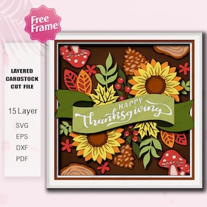 May include: A layered cardstock cut file design with a Thanksgiving theme. The design features sunflowers, leaves, pinecones, and mushrooms in shades of yellow, orange, red, and green. A green banner reads "Happy Thanksgiving".