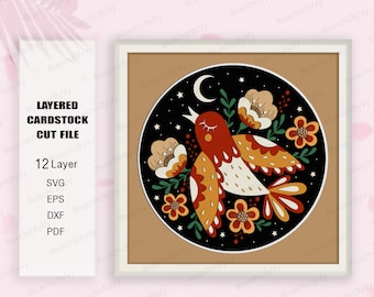 May include: A layered cardstock cut file design featuring a stylized bird with closed eyes singing in a circle of flowers and stars against a black background. The bird is red, orange, and white with a yellow beak. The flowers are pink, orange, and yellow. The stars are white. The moon is white with a crescent shape.