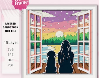 May include: A layered papercraft design featuring a silhouette of a person and a dog sitting on a wooden deck overlooking a lake with a sunset in the background. The design is framed by a window with a white frame.