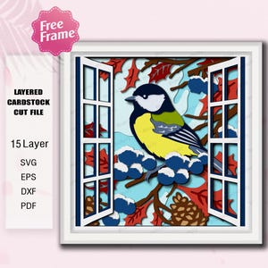 Peut inclure: Un fichier de découpe en carton multicouche représentant un oiseau coloré perché sur une branche avec des baies bleues et des feuilles rouges, vu à travers une fenêtre ouverte. Le design comprend le texte "Free Frame" et "LAYERED CARDSTOCK CUT FILE".