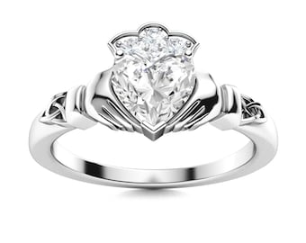 May include: A silver Celtic knot ring with a heart-shaped diamond center stone and smaller diamonds on the band.