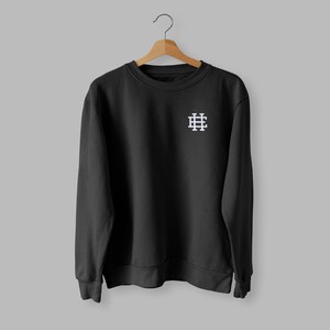 May include: Black sweatshirt with a white embroidered logo of a grid pattern on the left chest.