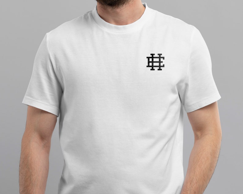 May include: White t-shirt with a black embroidered logo of a grid pattern with the letter "H" in the center.