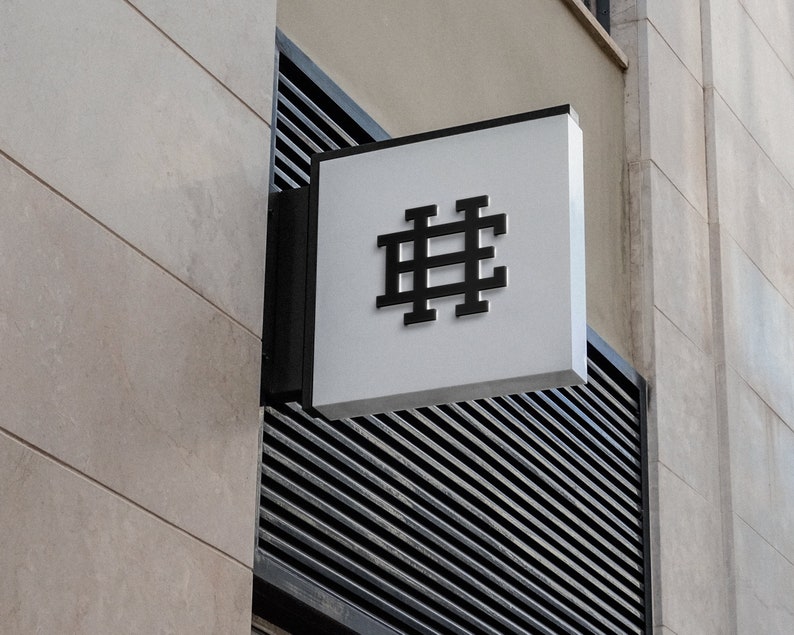 May include: A white sign with a black hashtag symbol on a building.