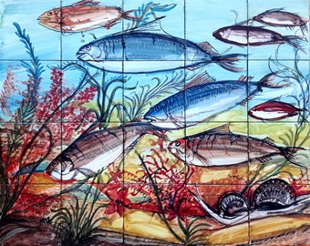 May include: A colorful ceramic tile mural depicting an underwater scene with various fish, seaweed, and coral. The fish are painted in shades of blue, red, and white, and the coral is a vibrant red.