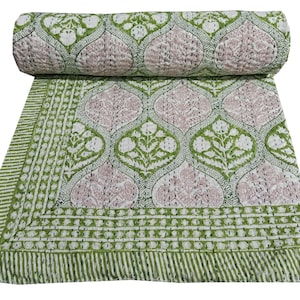 May include: Green and white cotton quilt with a floral pattern. The quilt has a border with a repeating pattern of small circles.