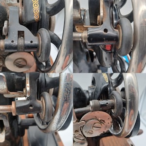May include: Close-up of a vintage sewing machine with black and silver metal parts. The machine has a large, round, silver-coloured wheel with a black band around the edge. There are several smaller wheels and gears visible. The machine is in good condition and appears to be well-used.
