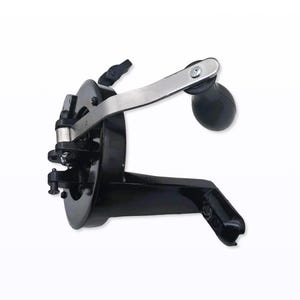 May include: A black, vintage-style can opener with a silver handle and a black, rounded handle. The can opener has a lever and a clamp for securing to a can. The design is a classic kitchen tool.