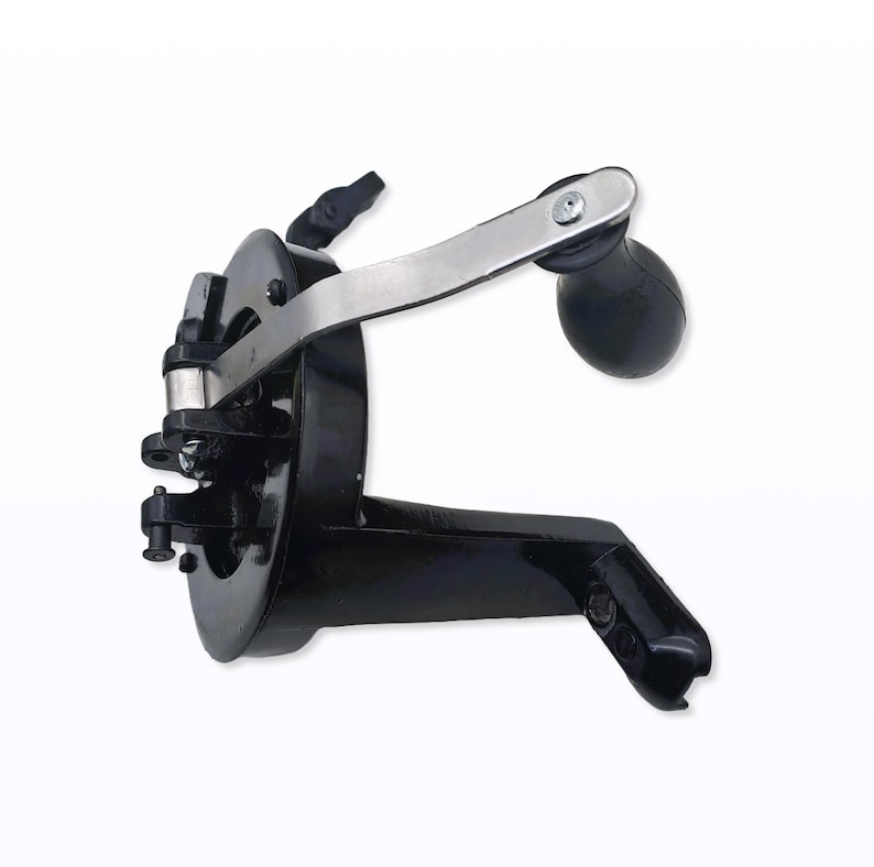 May include: A black, vintage-style can opener with a silver handle and a black, rounded handle. The can opener has a lever and a clamp for securing to a can. The design is a classic kitchen tool.