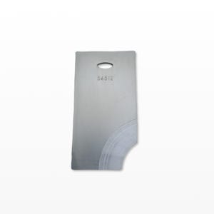 May include: A silver-coloured metal tag, rectangular with a curved cutout and an oval hole at the top. The number "54512" is etched near the top. The surface shows scratches and wear.