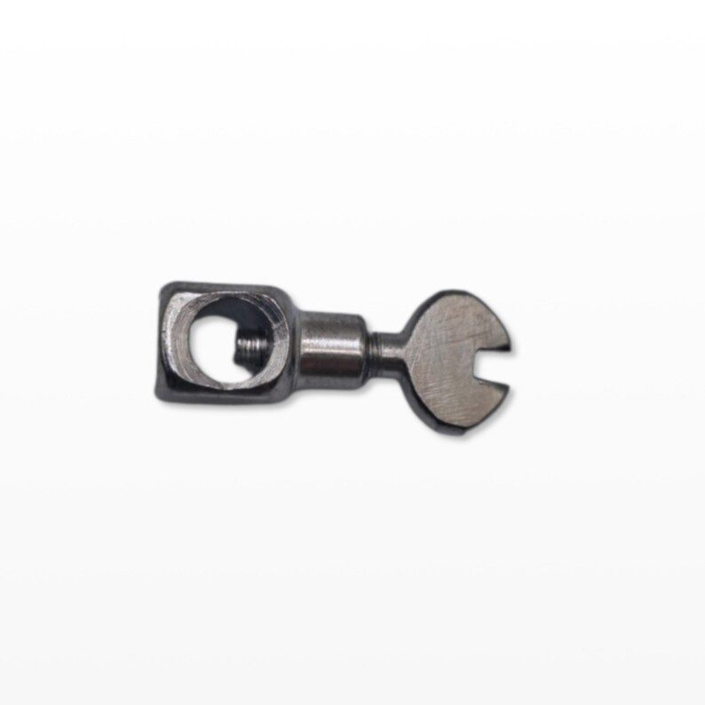 May include: A small, metallic wrench-like tool with a square head and a curved, open-ended design. The tool is silver-colored and appears to be made of metal. The background is plain white, highlighting the tool's shape and details.