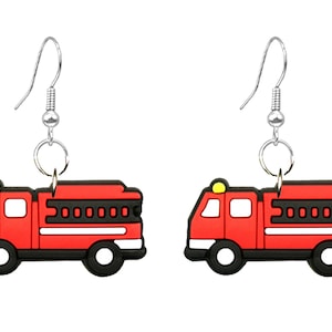 May include: A pair of novelty earrings featuring a red and black fire truck design. The earrings have silver-colored hooks and are shaped like miniature fire engines, with black wheels and a yellow light.