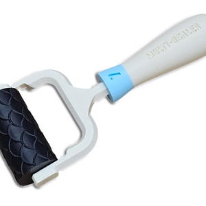 May include: A white and blue multi-sealer tool with a black patterned roller. The handle is white with the text "MULTI-SEALER" and a blue accent. The roller has a scale-like design.