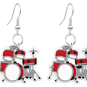 May include: A pair of novelty earrings featuring a red and white drum set design. The earrings have silver-colored hooks and are made of a lightweight material. The drum set includes a bass drum, snare drums, and cymbals.