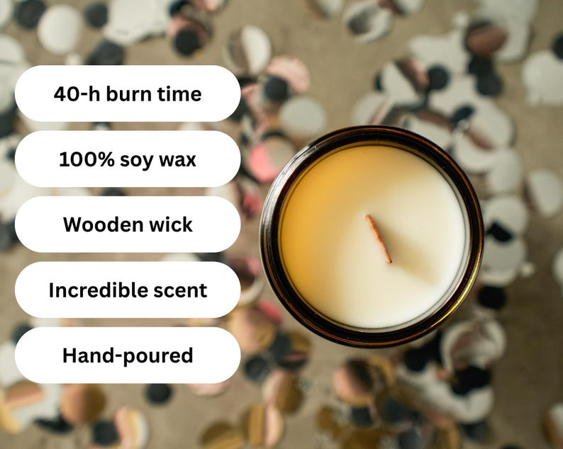 May include: Overhead view of a candle in a glass jar. The candle has a wooden wick and is filled with white wax. Text on the left indicates the candle has a 40-hour burn time, is made of 100% soy wax, and is hand-poured.