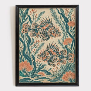 May include: A framed wall art print featuring two lionfish swimming among teal seaweed and orange coral-like plants. The illustration uses a muted color palette of teal, orange, and cream, set within a simple black rectangular frame.