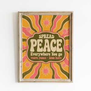 May include: A rectangular canvas wall art piece featuring a retro-inspired design with wavy vertical stripes in mustard yellow, olive green, and pink. The text reads SPREAD PEACE Everywhere You go more peace - less hate, accented by pink starbursts.