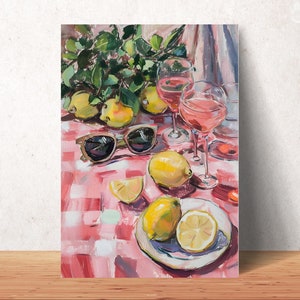 May include: An oil painting depicts a summer scene with lemons, pears, and wine glasses on a red and white checkered tablecloth. Sunglasses rest on the table. The painting has a bright, colorful, and inviting aesthetic.