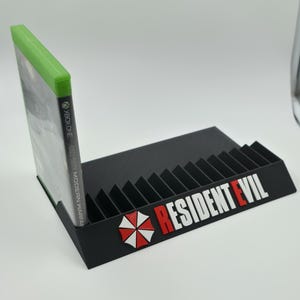 Expositor de 12 a 21 Ranuras de Juegos Microsoft Xbox One/ series s,x Logo resident evil