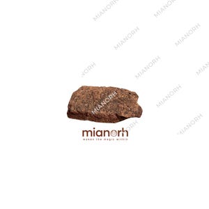 May include: A rough, dark brown, rectangular-shaped piece of natural material with a textured, uneven surface. Below the object, the text "mianorh" is printed in a dark brown font, followed by the smaller text "waken the magic within".
