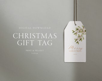 Könnte beinhalten: Ein weißes Weihnachtsgeschenkanhänger mit einem Mistelzweig-Design und den Worten "Merry Christmas". Der Anhänger ist 5 cm x 9,5 cm groß und wird von einer braunen Schnur gehalten. Auf dem Anhänger steht "Digitaler Download" und "Drucken & Ausfüllen".