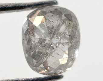May include: A round, gray, faceted diamond with a rough, natural finish.