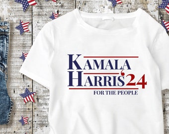 May include: White t-shirt with blue and red text that reads "Kamala Harris 24 for the people".
