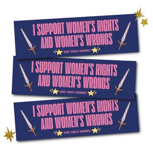 May include: Three navy blue rectangular stickers with the text "I SUPPORT WOMEN'S RIGHTS AND WOMEN'S WRONGS" in pink. Each sticker features a sword illustration and the phrase "GIVE! GIRLS! SWORDS!" with star accents. Gold glitter star accents are in the image.