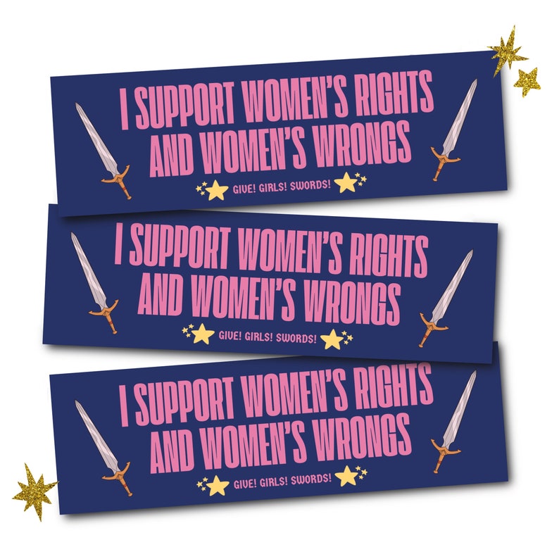 May include: Three navy blue rectangular stickers with the text "I SUPPORT WOMEN'S RIGHTS AND WOMEN'S WRONGS" in pink. Each sticker features a sword illustration and the phrase "GIVE! GIRLS! SWORDS!" with star accents. Gold glitter star accents are in the image.