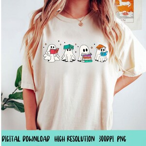 May include: A white t-shirt with a graphic of four ghosts reading books. The ghosts are wearing hats and holding books. The text "Bookish Ghosts" is printed on the shirt.