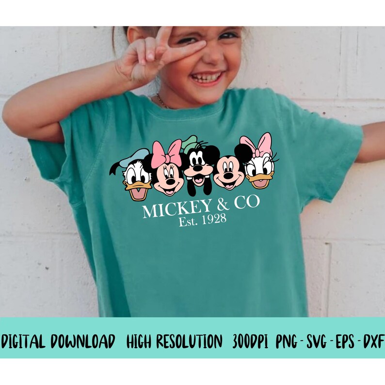 Puede incluir: Una camiseta turquesa con un gr&aacute;fico de Mickey Mouse y sus amigos. El texto "MICKEY & CO Est. 1928" est&aacute; impreso debajo del gr&aacute;fico.