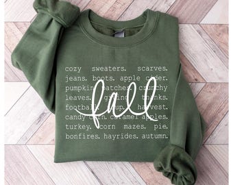 Pode incluir: Uma camisola verde-oliva com a palavra "fall" em fonte cursiva. A camisola tem uma lista de palavras com tema de outono em branco, incluindo "cozy sweaters", "pumpkin patches" e "hayrides". A parte inferior da imagem diz "DIGITAL DOWNLOAD HIGH RESOLUTION 300DPI PNG - SVG - EPS - DXF."