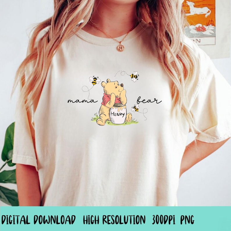 May include: Cream-colored t-shirt featuring a Winnie the Pooh graphic with the words "mama bear". The illustration shows Pooh Bear with a honey pot and bees. The text "DIGITAL DOWNLOAD HIGH RESOLUTION 300DPI PNG" is at the bottom.