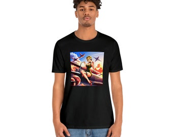 May include: Black t-shirt featuring a colorful graphic of a pin-up girl sitting on a vintage airplane, with fighter planes in the background. The artwork has a retro style with vibrant colors and details. The shirt is made of a soft material.
