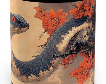 May include: Black and white ceramic mug with a black snake wrapped around a branch with red flowers. The snake has a red eye.
