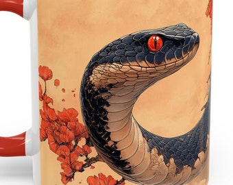 May include: White ceramic mug with a red rim. The mug features a black snake with a red eye wrapped around a branch of red blossoms on a beige background.