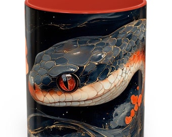 May include: A red and black coffee mug with a close-up image of a snake with a red eye. The snake is on a black background with gold and orange accents.