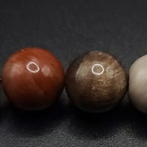 Petrified Wood Komboloi - Greek Worry Beads
Each piece is hand assembled with 100% natural stones and consists of  25 beads - 21 in the body - 4 at the top with an antique silver plated shield.