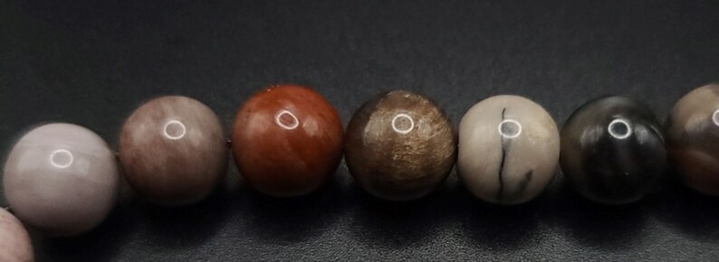 Petrified Wood Komboloi - Greek Worry Beads
Each piece is hand assembled with 100% natural stones and consists of  25 beads - 21 in the body - 4 at the top with an antique silver plated shield.